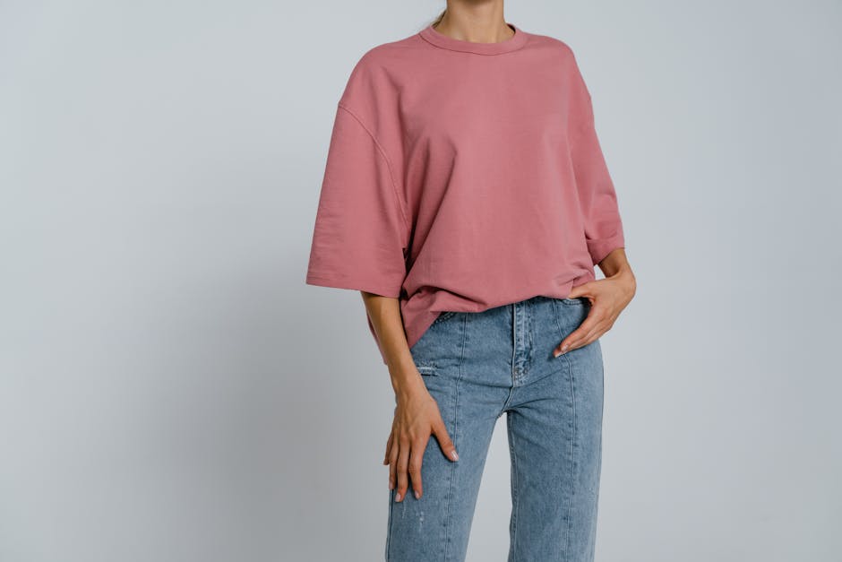 Model wearing a pink t-shirt and jeans, perfect for casual wear mockups.